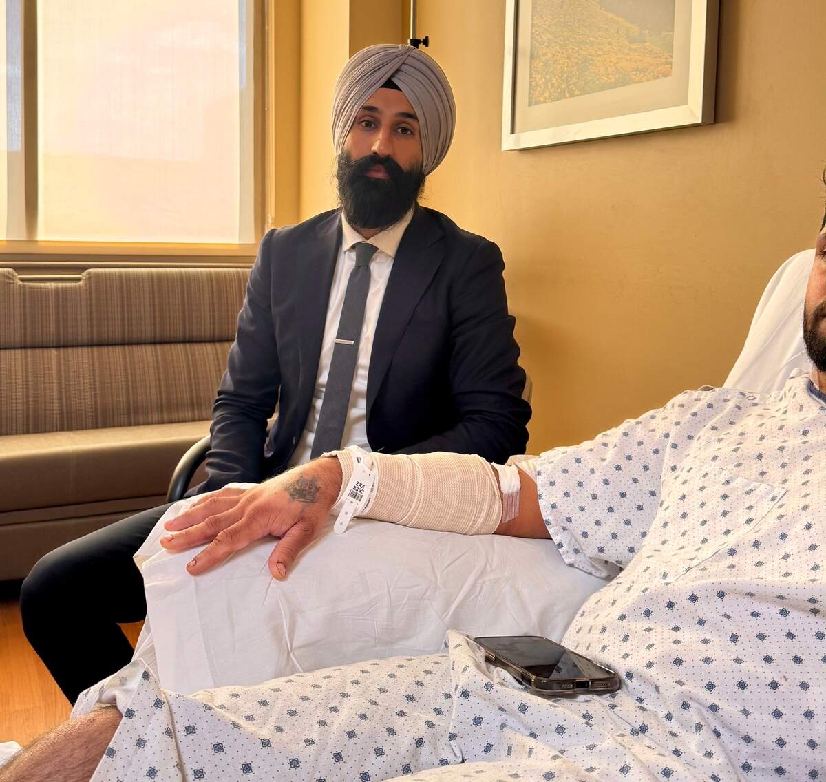 Jasjit Singh Dhanoa, Jakara Movement director of legal services, talks with a Sacramento truck driver who was attacked in Wyoming on Sunday, Sept. 13, 2026.